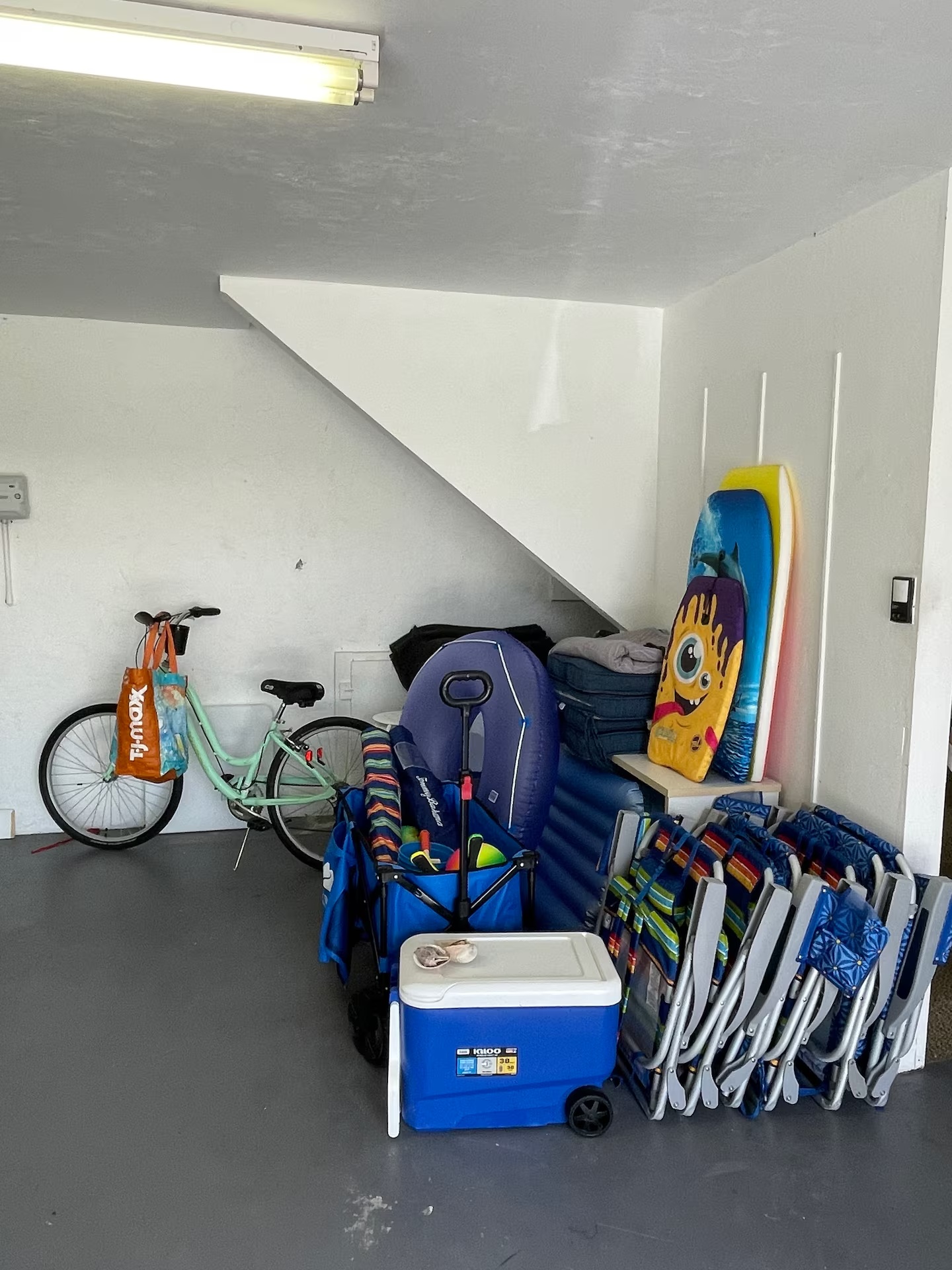 Beach gear provided for guests including bicycles, chairs, cooler, floats and boards