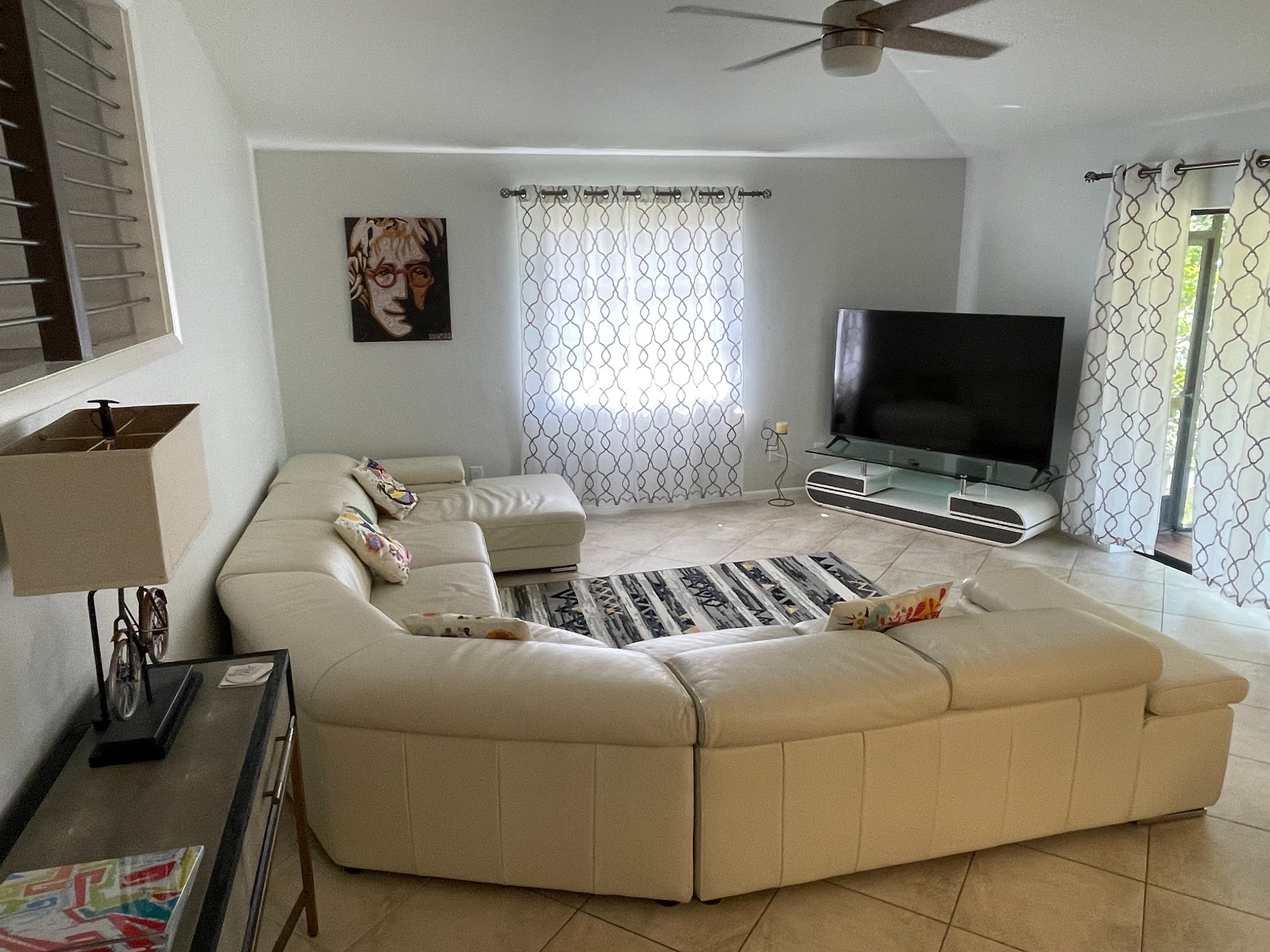 Large living room with sectional seating and TV